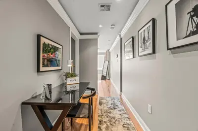 a hallway with a desk and paintings on the walls at 5 bdrm - Heated Indoor Pool - Elevator in Philadelphia