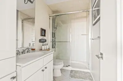 a bathroom with a shower and a sink and a toilet at 5 bdrm - Heated Indoor Pool - Elevator in Philadelphia