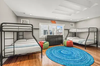 two bunk beds in a room with a rug at 5 bdrm - Heated Indoor Pool - Elevator in Philadelphia