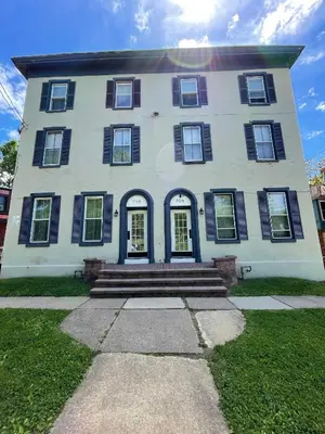 a large white house with black shuttered windows and stairs at The loft at Park Place - 3rd floor walk up King and Queen beds fast WIFI and free coffee in Wilmington