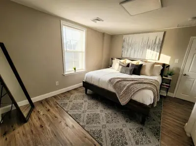 a bedroom with a large bed and a window at The loft at Park Place - 3rd floor walk up King and Queen beds fast WIFI and free coffee in Wilmington