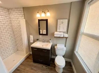 a bathroom with a toilet and a sink and a shower at The loft at Park Place - 3rd floor walk up King and Queen beds fast WIFI and free coffee in Wilmington