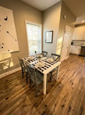 a dining room with a white table and chairs at The loft at Park Place - 3rd floor walk up King and Queen beds fast WIFI and free coffee in Wilmington