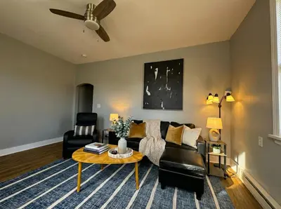 a living room with a couch and a table at Modern cozy unit with King Bed in Wilmington