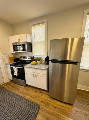 a kitchen with a large stainless steel refrigerator at Modern cozy unit with King Bed in Wilmington