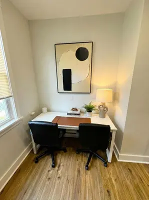 an office with a desk with two chairs and a lamp at Modern cozy unit with King Bed in Wilmington