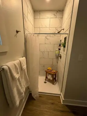 a bathroom with a shower with a glass door at Modern cozy unit with King Bed in Wilmington