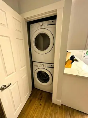 a washer and dryer in a small room at Modern cozy unit with King Bed in Wilmington