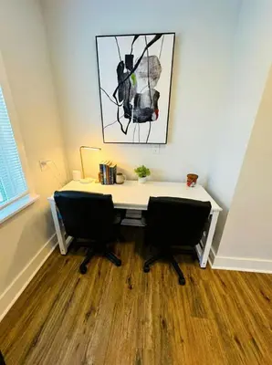 an office with a white desk and two chairs at Modern Cozy walk up with King Bed in Wilmington