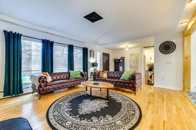 a living room with leather couches and a table at Game Room and Hot Tub! Cresco Family Home in Cresco