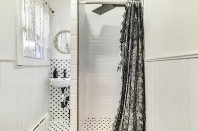 a bathroom with a shower curtain and a sink at Game Room and Hot Tub! Cresco Family Home in Cresco