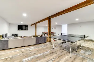 a living room with a ping pong table and a couch at Game Room and Hot Tub! Cresco Family Home in Cresco