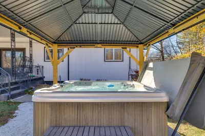 a hot tub in a gazebo with a roof at Game Room and Hot Tub! Cresco Family Home in Cresco