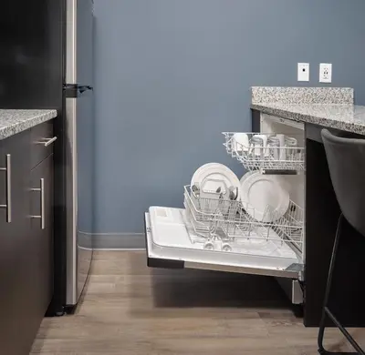 a dishwasher with dishes in it in a kitchen at stayAPT Suites Harrisburg-Hershey in Harrisburg