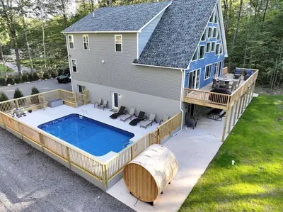 a house with a large swimming pool with a large deck at Dulce Retreat in Blakeslee