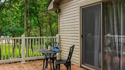 a patio with a table and two chairs on a porch at Frolic on Fern by AvantStay Enclosed Deck w Forest Views Bar in Blakeslee