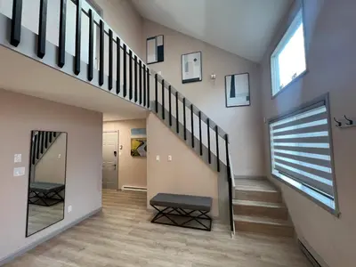 a staircase in a house with a window and a bench at Elegant saver spot in Poconos in East Stroudsburg
