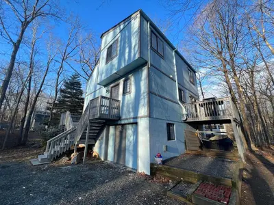 a house with a staircase on the side of it at Elegant saver spot in Poconos in East Stroudsburg