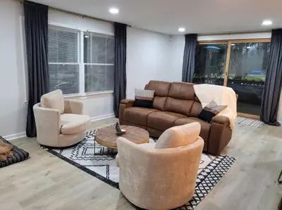 a living room with a couch and two chairs at Lake Luxe in Lake Ariel