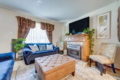 a living room with a fireplace and a tv at Tobyhanna Home with Fire Pit 1 Mi to Lake Carobeth! in Tobyhanna