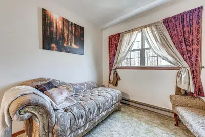 a living room with a couch and a window at Tobyhanna Home with Fire Pit 1 Mi to Lake Carobeth! in Tobyhanna