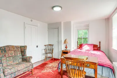 a bedroom with a bed and a couch and a chair at Tranquil and Historic Estate Near Valley Forge in Eagleville