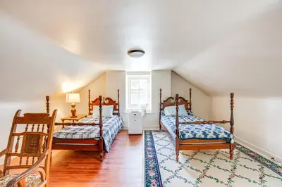 a bedroom with two beds and a rug at Tranquil and Historic Estate Near Valley Forge in Eagleville