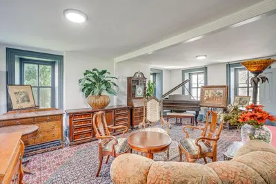 a living room filled with furniture and a piano at Tranquil and Historic Estate Near Valley Forge in Eagleville