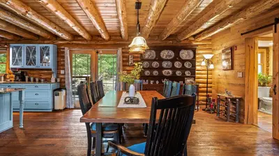 a dining room with a wooden table and chairs at Bigwood Cabin Near Camelback Skiing Hot Tub Game Room Firepit Yard in Long Pond