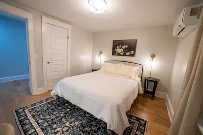 a bedroom with a white bed and a door at Prime Location on Main Street in Stroudsburg