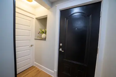 a black door in a hallway with white walls at Prime Location on Main Street in Stroudsburg