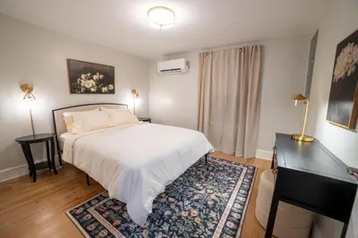 a bedroom with a bed and a dresser in it at Prime Location on Main Street in Stroudsburg