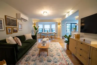 a living room with a green couch and a table at Prime Location on Main Street in Stroudsburg