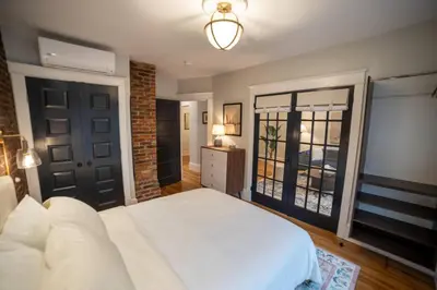 a bedroom with a large white bed and a window at Apt in the heart of Main Street in Stroudsburg