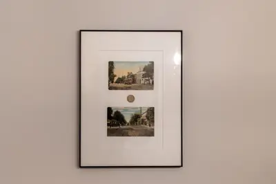 a framed picture of photographs on a wall at Apt in the heart of Main Street in Stroudsburg