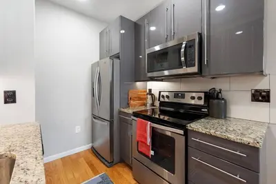 a kitchen with stainless steel appliances and granite counter tops at Beautiful 1BD With Balcony Hosted By StayRafa - 3F in Philadelphia