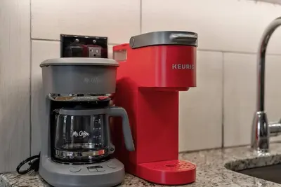a red coffee maker sitting on a kitchen counter at Beautiful 1BD With Balcony Hosted By StayRafa - 3F in Philadelphia