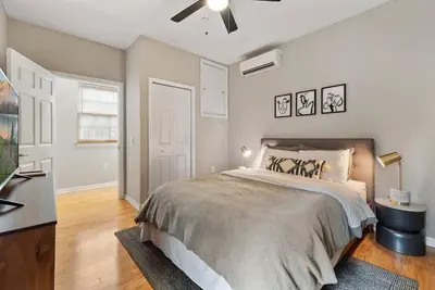 a bedroom with a bed and a ceiling fan at Beautiful 1BD With Balcony Hosted By StayRafa - 3F in Philadelphia