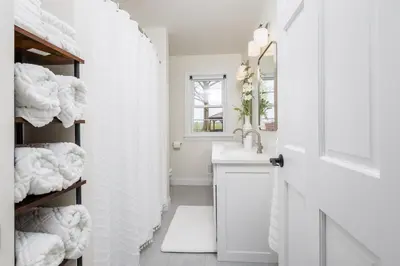 a bathroom with a sink and a shower with towels at Backyard Getaway•Amish Farmland•Hot tub•Fire pit in Bird in Hand