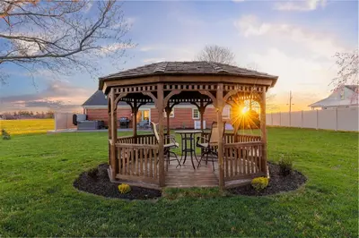 a gazebo with a table and chairs in a yard at Backyard Getaway•Amish Farmland•Hot tub•Fire pit in Bird in Hand