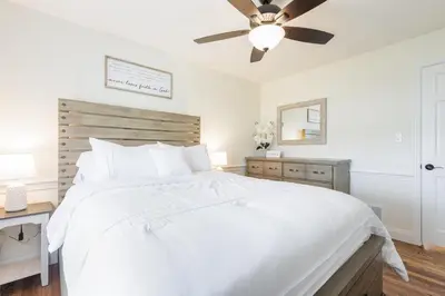 a bedroom with a white bed and a ceiling fan at Backyard Getaway•Amish Farmland•Hot tub•Fire pit in Bird in Hand