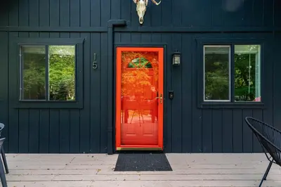a blue house with a red door and windows at Updated 3 BDR Gas Fire Place BBQ in Albrightsville