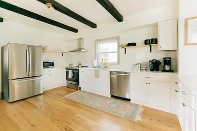 a kitchen with white cabinets and stainless steel appliances at Quaint Vintage Reno in Manheim in Manheim