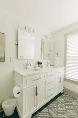 a white bathroom with a sink and a mirror at Quaint Vintage Reno in Manheim in Manheim