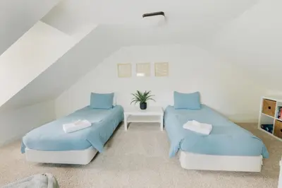 two beds with blue sheets in a room at Getaway on Grant heart of Downtown with parking in Lancaster