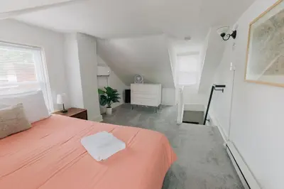 a bedroom with a large orange bed in a room at Comfy renovated townhome - heart of Downtown Lancaster in Lancaster