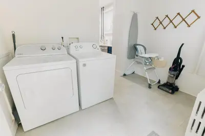 a white laundry room with a washer and dryer at Comfy renovated townhome - heart of Downtown Lancaster in Lancaster