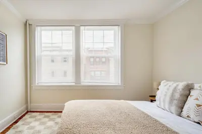 a bedroom with a bed and a large window at Dreamy 2BR in Downtown Princeton in Princeton