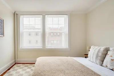 a bedroom with a bed and a large window at Dreamy 2BR in Downtown Princeton in Princeton