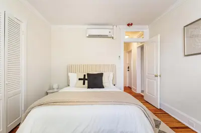 a bedroom with a bed with white walls at Dreamy 2BR in Downtown Princeton in Princeton